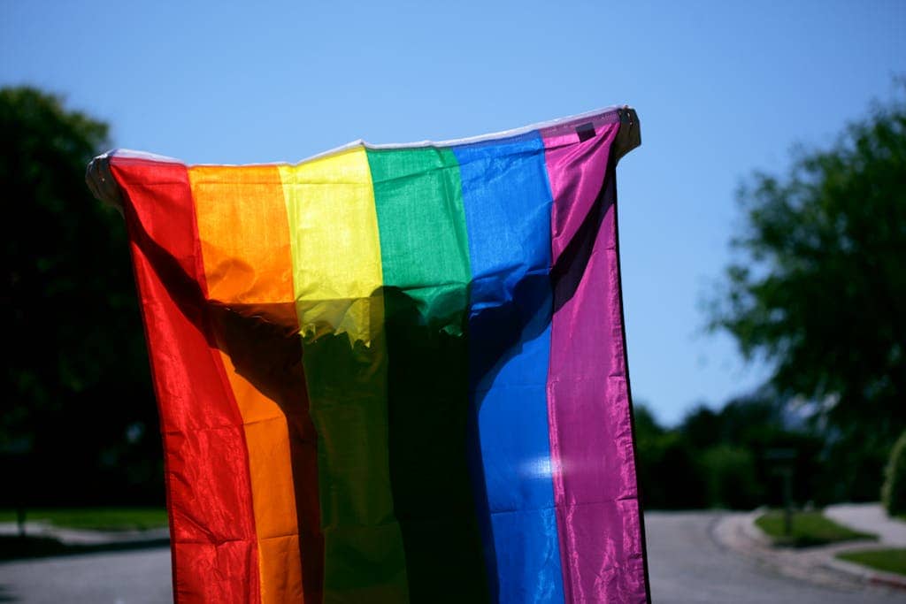 Bright rainbow pride flag showcased in an outdoor setting, highlighting colors and unity.